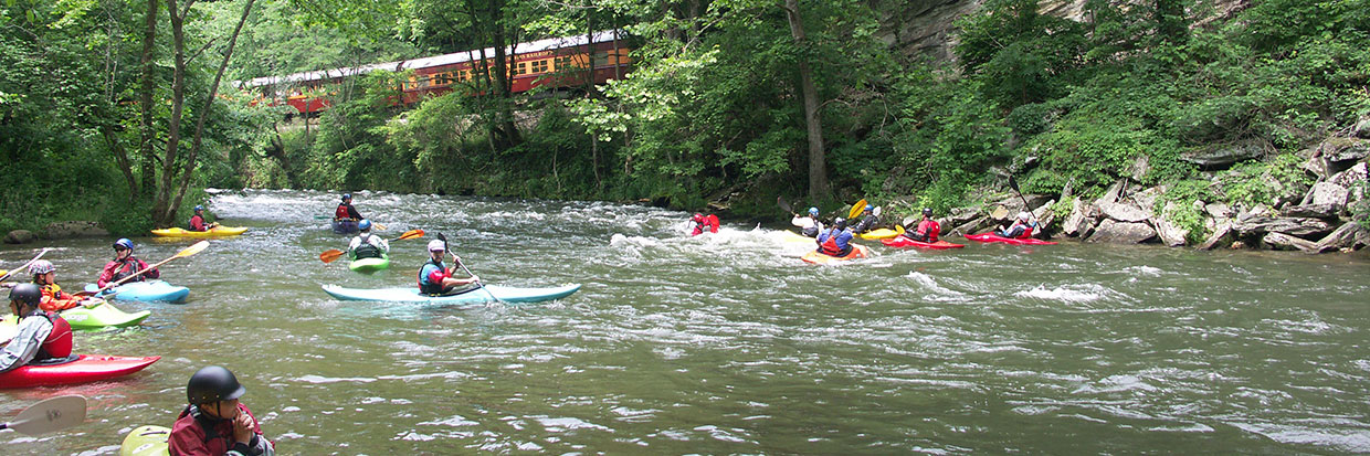 Kayakers on the Nantahala with scenic railroad in background